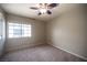 Bedroom features neutral walls, a large window, and a ceiling fan at 220 Hollyfern St, Henderson, NV 89074
