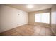 Bright bedroom featuring neutral walls, tiled floors, and a window with blinds at 220 Hollyfern St, Henderson, NV 89074