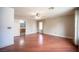 Bright bedroom with hardwood floors, ceiling fan, and view to the bathroom at 220 Hollyfern St, Henderson, NV 89074