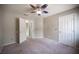 Carpeted bedroom with ceiling fan, neutral walls and open doorframe at 220 Hollyfern St, Henderson, NV 89074