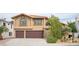 Charming two-story home featuring a stucco exterior, a two-car garage, and well-maintained landscaping at 220 Hollyfern St, Henderson, NV 89074