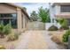 View of the gated driveway leading to the backyard, featuring desert landscaping and pavers at 220 Hollyfern St, Henderson, NV 89074