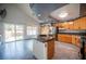 Modern kitchen featuring granite countertops, stainless steel appliances, and sliding glass doors to the backyard at 220 Hollyfern St, Henderson, NV 89074