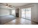 Cozy living room with fireplace, sliding glass doors to backyard pool, and neutral carpeting at 220 Hollyfern St, Henderson, NV 89074