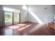 Spacious living room featuring hardwood floors, large windows, and a staircase at 220 Hollyfern St, Henderson, NV 89074