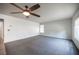 Spacious living room with plush carpeting, bright windows, and a modern ceiling fan at 220 Hollyfern St, Henderson, NV 89074