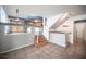 Open-concept living space featuring tiled floors, stairs to the kitchen, and a unique architectural design at 220 Hollyfern St, Henderson, NV 89074