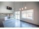 Living area with pool view, high ceilings, pendant lights, and lots of natural light at 220 Hollyfern St, Henderson, NV 89074