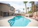 Lush backyard featuring a sparkling pool, a hot tub, mature trees, and a relaxing outdoor space at 220 Hollyfern St, Henderson, NV 89074