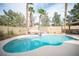 Sparkling pool with a diving board, surrounded by a patio, lush greenery, and a hot tub at 220 Hollyfern St, Henderson, NV 89074