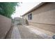 View of the side yard, featuring a secured and gated driveway and desert landscaping along the property at 220 Hollyfern St, Henderson, NV 89074