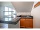 Modern wet bar with granite countertop, wood cabinetry, and sink for entertaining at 220 Hollyfern St, Henderson, NV 89074
