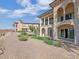 Spacious backyard with desert landscaping, stone retaining wall, and multi-story stucco building at 24 Via Vasari # 104, Henderson, NV 89011