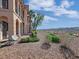 Expansive backyard with desert landscaping, manicured bushes, and view of the city in the distance at 24 Via Vasari # 104, Henderson, NV 89011
