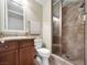 Bathroom with tile shower, vanity, and toilet at 24 Via Vasari # 104, Henderson, NV 89011