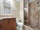 Bathroom with tile shower, vanity, and toilet at 24 Via Vasari # 104, Henderson, NV 89011
