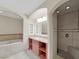 Bathroom featuring a soaking tub, vanity with storage, and a separate tiled shower at 24 Via Vasari # 104, Henderson, NV 89011