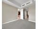 Empty bedroom with carpeting and doorways leading to the kitchen and other rooms at 24 Via Vasari # 104, Henderson, NV 89011