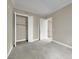 Bedroom features neutral carpet, large closet, and a doorway leading to another room at 24 Via Vasari # 104, Henderson, NV 89011