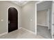 Foyer with a dark wood door, tile flooring, and open access to other rooms at 24 Via Vasari # 104, Henderson, NV 89011
