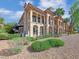 Stucco home with manicured yard, tile roof, and multiple stories with balconies at 24 Via Vasari # 104, Henderson, NV 89011