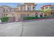 Charming townhouse with a tile roof, manicured landscaping, and a two-car garage at 24 Via Vasari # 104, Henderson, NV 89011