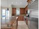 Modern kitchen featuring custom cabinetry, stainless steel appliances, and a large island with a granite countertop at 24 Via Vasari # 104, Henderson, NV 89011