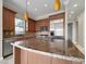 Modern kitchen with stainless steel appliances, granite counters, and custom cabinets at 24 Via Vasari # 104, Henderson, NV 89011