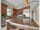 Gourmet kitchen featuring granite countertops, stainless steel appliances, and custom cabinetry at 24 Via Vasari # 104, Henderson, NV 89011