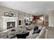 Open-concept living room with fireplace, recessed lighting, and an adjacent kitchen at 24 Via Vasari # 104, Henderson, NV 89011