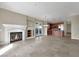 Expansive living room featuring an open layout, modern fireplace, and access to the kitchen at 24 Via Vasari # 104, Henderson, NV 89011