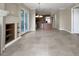 Spacious living area showcasing an open layout with a fireplace and kitchen access at 24 Via Vasari # 104, Henderson, NV 89011