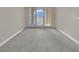 Bright living room featuring sliding glass doors with beautiful views and neutral carpeting at 24 Via Vasari # 104, Henderson, NV 89011