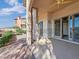 Inviting covered patio with brick flooring, offering an ideal outdoor space for relaxation and beautiful landscape views at 24 Via Vasari # 104, Henderson, NV 89011