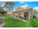 Backyard featuring a covered patio, well-manicured lawn, and desert landscaping at 2424 Chestnut Hill St, Las Vegas, NV 89134