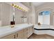 Bright bathroom featuring a soaking tub, dual sinks, and ample counter space at 2424 Chestnut Hill St, Las Vegas, NV 89134