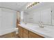 Bright bathroom with dual sinks, white tiled shower and spacious vanity at 2424 Chestnut Hill St, Las Vegas, NV 89134