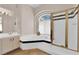 Bathroom showcasing a luxurious soaking tub, step-in shower, and tiled accents at 2424 Chestnut Hill St, Las Vegas, NV 89134