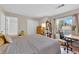Bedroom with wood-look floors, desk, and large closet with sliding doors at 2424 Chestnut Hill St, Las Vegas, NV 89134