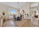 Dining area features stone flooring, large bright window and modern light fixture at 2424 Chestnut Hill St, Las Vegas, NV 89134