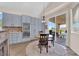 Kitchen dining area features a round wood table, tile floors, and sliding glass doors to the backyard at 2424 Chestnut Hill St, Las Vegas, NV 89134