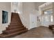 Entryway with wood staircase leading to the upper level, highlighted by stone tile flooring at 2424 Chestnut Hill St, Las Vegas, NV 89134