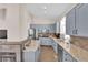 Well-lit kitchen with blue cabinets, granite countertops, and stainless steel appliances at 2424 Chestnut Hill St, Las Vegas, NV 89134