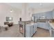 Living area with blue cabinets, stainless steel appliances, and a central fireplace at 2424 Chestnut Hill St, Las Vegas, NV 89134