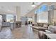 Open-concept living area featuring stone tile flooring, fireplace, and large windows allowing ample natural light at 2424 Chestnut Hill St, Las Vegas, NV 89134