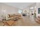 Spacious open concept living area with stone tile flooring, comfortable seating, and natural light at 2424 Chestnut Hill St, Las Vegas, NV 89134