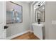 Sleek powder room featuring modern fixtures, stylish lighting, and eye-catching artwork at 2548 Faiss Dr, Las Vegas, NV 89134