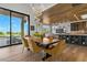 Open dining area adjacent to the kitchen with wood flooring and a view to the outdoors at 2548 Faiss Dr, Las Vegas, NV 89134