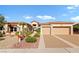 Single-story house with a two-car garage and xeriscaping against a clear blue sky at 2548 Faiss Dr, Las Vegas, NV 89134