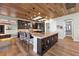 Gourmet kitchen featuring a large center island with seating and sleek, dark cabinetry at 2548 Faiss Dr, Las Vegas, NV 89134